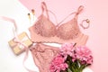 Female lace pink underwear with a pink ribbon on pink background