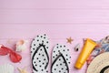 Flat lay composition with flip flops and beach accessories on pink background. Space for text Royalty Free Stock Photo