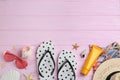 Flat lay composition with flip flops and beach accessories on pink background. Space for text Royalty Free Stock Photo