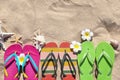 Flat lay composition with flip flops on sand in summer. Beach accessories Royalty Free Stock Photo