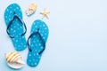 Flat lay composition with flip flops and seashell on colored background. Space for text top view Royalty Free Stock Photo