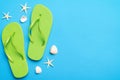 Flat lay composition with flip flops and seashell on colored background. Space for text top view Royalty Free Stock Photo
