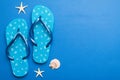 Flat lay composition with flip flops and seashell on colored background. Space for text top view Royalty Free Stock Photo