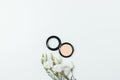 Flat lay composition of flowers and makeup compact powder Royalty Free Stock Photo