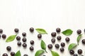 Flat lay composition with fresh acai berries and leaves Royalty Free Stock Photo