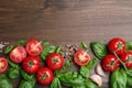 Flat lay composition with fresh basil leaves and vegetables on wooden table. Space for text Royalty Free Stock Photo