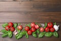 Flat lay composition with fresh basil leaves and vegetables on wooden table. Space for text Royalty Free Stock Photo