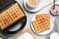 Flat lay composition with fresh Belgian waffles on grey marble table