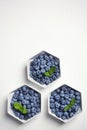 Flat lay composition with fresh blueberries, green leaves and space for text Royalty Free Stock Photo