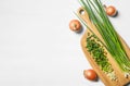 Flat lay composition with fresh green onion on white wooden table. Space for text Royalty Free Stock Photo