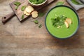 Flat lay composition with fresh  healthy spinach soup on wooden table, space for text Royalty Free Stock Photo