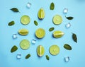 Flat lay composition with juicy limes, mint and ice cubes on light blue background Royalty Free Stock Photo