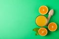 Flat lay composition with fresh orange juice, wooden juicer and oranges with leaves on color background, space for text Royalty Free Stock Photo