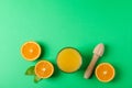 Flat lay composition with fresh orange juice, wooden juicer and oranges with leaves on color background, space for text Royalty Free Stock Photo