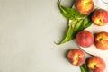 Flat lay composition with fresh peaches and leaves on grey stone surface Royalty Free Stock Photo