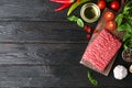 Flat lay composition with fresh raw minced meat on black wooden table. Space for text Royalty Free Stock Photo