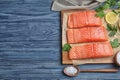 Flat lay composition with fresh raw salmon on wooden table, space for text. Fish delicacy Royalty Free Stock Photo