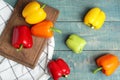 Flat lay composition with fresh ripe bell peppers on blue wooden Royalty Free Stock Photo