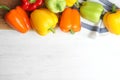 Flat lay composition with fresh ripe bell peppers on white wooden table Royalty Free Stock Photo