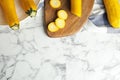 Flat lay composition with fresh ripe yellow zucchinis on table, space for text