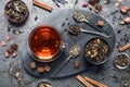 Flat lay composition with freshly brewed tea and dry leaves on grey table Royalty Free Stock Photo