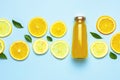 Flat lay composition with glass bottles of juice or fresh, slices of fresh lemon and orange, green leaves, ice cubes on Royalty Free Stock Photo