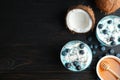 Flat lay composition with glass cups of spirulina smoothie and space for text on black Royalty Free Stock Photo