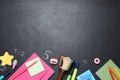 Flat lay composition with golden bell and school stationery on blackboard, space for text Royalty Free Stock Photo