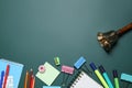 Flat lay composition with golden bell and school stationery on green chalkboard, space for text Royalty Free Stock Photo