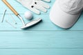 Flat lay composition with golf accessories on blue wooden background