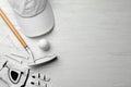 Flat lay composition with golf accessories on white wooden background