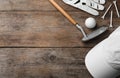 Flat lay composition with golf accessories on wooden background