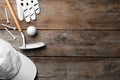 Flat lay composition with golf accessories on wooden background