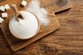 Flat lay composition with granulated sugar on wooden table