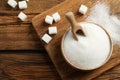 Flat lay composition with granulated sugar on wooden table