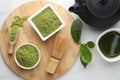 Flat lay composition with green matcha powder on white marble table Royalty Free Stock Photo