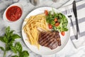 Flat lay composition with grilled beef steak on marble table