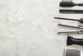 Flat lay composition with Hairdresser tools: scissors, combs, hair iron, hair dryer on gray background with copy space for text. Royalty Free Stock Photo