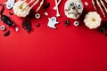 Flat lay composition with Halloween holiday decorations on red background