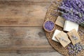 Flat lay composition of handmade soap bars with lavender flowers on brown wooden background Royalty Free Stock Photo