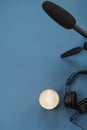 Flat lay composition with Headphones, microphone and coffee on a blue background. Podcast or webinar concept Royalty Free Stock Photo