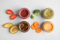 Flat lay composition with healthy baby food and ingredients on grey background Royalty Free Stock Photo