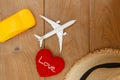 Flat lay  composition with heart shape and  airplane model ,toy car on wooden background . Royalty Free Stock Photo