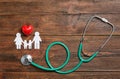Flat lay composition with heart, stethoscope and family silhouette Royalty Free Stock Photo