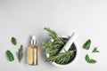 Flat lay composition with herbal essential oil on light background Royalty Free Stock Photo