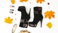 Flat lay composition with high heel boots and yellow leaves on white background. Autumn season Royalty Free Stock Photo