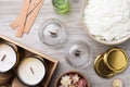 Flat lay composition with homemade candles and ingredients on light wooden background Royalty Free Stock Photo