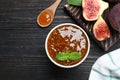 Flat lay composition with homemade delicious fig jam on black wooden table Royalty Free Stock Photo