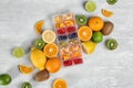 Flat lay composition with ice cube tray and fresh fruits Royalty Free Stock Photo