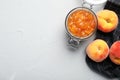 Flat lay composition with jar of tasty peach jam